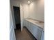Modern bathroom features a double vanity with white cabinets and stone countertops at 3315 Godby Dr, Sheridan, IN 46069