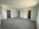 Spacious carpeted bedroom with multiple doors and windows offering ample light at 3315 Godby Dr, Sheridan, IN 46069