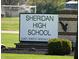 A picturesque view of the Sheridan High School sign set against a backdrop of lush greenery at 3315 Godby Dr, Sheridan, IN 46069