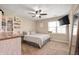 Neutral bedroom showcasing carpet, ceiling fan, and window view with a mounted TV at 3510 Oak Tree Cir, Indianapolis, IN 46227