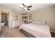 Comfortable bedroom features neutral paint, ceiling fan, carpet flooring, and a bookcase at 3510 Oak Tree Cir, Indianapolis, IN 46227