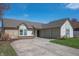 Well-maintained single-story home featuring a two-car garage and an asphalt driveway at 3510 Oak Tree Cir, Indianapolis, IN 46227