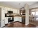 Efficient kitchen with stainless steel appliances, white cabinets, and dark hardwood floors at 3510 Oak Tree Cir, Indianapolis, IN 46227