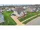 Stunning aerial view of a two-story home with manicured lawns, a long driveway, and a three-car garage at 3665 Conifer Dr, Zionsville, IN 46077