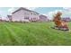 Well-maintained backyard featuring a lush green lawn and two-story house, creating a serene outdoor space at 3665 Conifer Dr, Zionsville, IN 46077