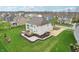 Spacious backyard featuring a wooden deck, stone path, and manicured garden beds at 3665 Conifer Dr, Zionsville, IN 46077