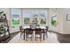 Bright dining area features large windows, hardwood floors, and a view of the backyard at 3665 Conifer Dr, Zionsville, IN 46077