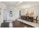 Elegant dining room with hardwood floors, stylish lighting, and a welcoming entryway with a decorated glass door at 3665 Conifer Dr, Zionsville, IN 46077