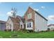 Charming home featuring brick and stone accents, complemented by a well-manicured lawn and garden at 3665 Conifer Dr, Zionsville, IN 46077