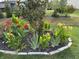 Landscaped flower garden with vibrant red and yellow flowers, adding charm to the well-maintained yard at 3665 Conifer Dr, Zionsville, IN 46077