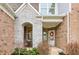 Inviting front porch with stone accents, decorative wreath, and a cozy seating area at 3665 Conifer Dr, Zionsville, IN 46077