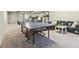 Basement game room with carpeted flooring, ping pong table, and comfortable seating area at 3665 Conifer Dr, Zionsville, IN 46077