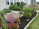 Lush garden featuring a variety of colorful flowers, plants, and mulch for a beautiful landscape at 3665 Conifer Dr, Zionsville, IN 46077