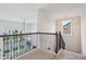 Bright hallway features a stylish chandelier, iron banister, and ample natural light at 3665 Conifer Dr, Zionsville, IN 46077