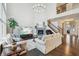 Inviting living room featuring a stone fireplace, plush sofas, and a staircase leading to the upper level at 3665 Conifer Dr, Zionsville, IN 46077