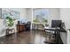 Spacious home office with hardwood floors, a large window, and modern desk setups for a productive workspace at 3665 Conifer Dr, Zionsville, IN 46077