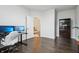 Bright office space features dark hardwood floors, neutral walls, and multiple monitors for optimal productivity at 3665 Conifer Dr, Zionsville, IN 46077