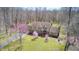 An aerial view of a spacious home nestled in a wooded area, surrounded by lush greenery and mature trees at 3753 Whippoorwill Lake S Dr, Monrovia, IN 46157