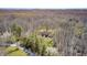 A beautiful home surrounded by vibrant flowering trees and mature forest, creating a serene and picturesque setting at 3753 Whippoorwill Lake S Dr, Monrovia, IN 46157