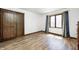 Spacious bedroom with hardwood floors, a door and a window with curtains at 3753 Whippoorwill Lake S Dr, Monrovia, IN 46157