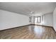 Primary bedroom with wood floors, neutral walls, ceiling fan, and window with floral curtains at 3753 Whippoorwill Lake S Dr, Monrovia, IN 46157