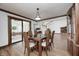 Dining room with wood floors, a dark wood display cabinet, and access to a sunroom at 3753 Whippoorwill Lake S Dr, Monrovia, IN 46157