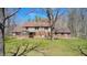 An attractive home offers a brick exterior, and green lawn amidst the shade of bare trees at 3753 Whippoorwill Lake S Dr, Monrovia, IN 46157