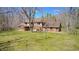 A traditional home on a verdant lot has a brick exterior and is surrounded by bare trees at 3753 Whippoorwill Lake S Dr, Monrovia, IN 46157