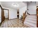 Bright and open foyer with patterned tile flooring, a staircase, and views into the adjoining rooms at 3753 Whippoorwill Lake S Dr, Monrovia, IN 46157