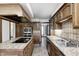 Kitchen features an island cooktop, wood cabinets and an opening to another room at 3753 Whippoorwill Lake S Dr, Monrovia, IN 46157