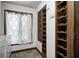 Laundry room featuring a window with sheer curtains, built-in storage shelves, and a washing machine at 3753 Whippoorwill Lake S Dr, Monrovia, IN 46157