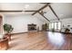 Spacious living room with a vaulted ceiling, brick fireplace, and hardwood floors, perfect for relaxation and entertainment at 3753 Whippoorwill Lake S Dr, Monrovia, IN 46157