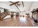 Open-concept living room with hardwood floors, a brick fireplace, and large windows, offering a seamless flow at 3753 Whippoorwill Lake S Dr, Monrovia, IN 46157