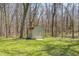 A backyard shed with double doors provides ample storage space on the verdant lawn at 3753 Whippoorwill Lake S Dr, Monrovia, IN 46157
