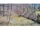 Scenic view of a small stream with a wooden dock, surrounded by natural woodland vegetation at 3753 Whippoorwill Lake S Dr, Monrovia, IN 46157