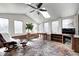 Cozy sun room with brick floors, skylights, a ceiling fan, and multiple windows at 3753 Whippoorwill Lake S Dr, Monrovia, IN 46157