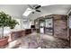 Sun room with brick floors, multiple windows, a ceiling fan, and access to the backyard at 3753 Whippoorwill Lake S Dr, Monrovia, IN 46157