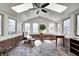 Bright sun room with brick flooring, skylights, and large windows offering plenty of natural light at 3753 Whippoorwill Lake S Dr, Monrovia, IN 46157