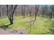 A spacious green yard is partially covered by the shadows of the bare trees at 3753 Whippoorwill Lake S Dr, Monrovia, IN 46157