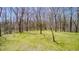 A spacious green lawn is partially covered by the shadows of the bare trees at 3753 Whippoorwill Lake S Dr, Monrovia, IN 46157