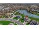 An aerial view showcases a charming neighborhood near a playground and scenic pond at 419 Dovetree Dr, Danville, IN 46122