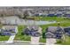 Aerial view of a brick home next to a pond surrounded by well-maintained lawns and trees at 419 Dovetree Dr, Danville, IN 46122