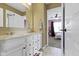 Well-lit bathroom vanity area with double sinks and view into a bedroom at 419 Dovetree Dr, Danville, IN 46122