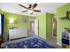 Bright bedroom with ceiling fan, carpet floors, and a glimpse of an en-suite bathroom at 419 Dovetree Dr, Danville, IN 46122