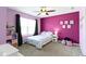 Bedroom features a ceiling fan, light purple walls, large window, and carpet floors at 419 Dovetree Dr, Danville, IN 46122