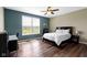 Comfortable bedroom featuring a large window, wood floors, and neutral decor at 419 Dovetree Dr, Danville, IN 46122
