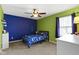 Cozy bedroom with blue and green walls, ceiling fan, and window with natural light at 419 Dovetree Dr, Danville, IN 46122