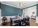 Elegant dining room with wainscoting detail, decorative lighting, and hardwood floors at 419 Dovetree Dr, Danville, IN 46122