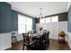 Formal dining room featuring wainscoting, modern lighting, and hardwood floors at 419 Dovetree Dr, Danville, IN 46122
