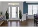 Bright foyer featuring beautiful wood floors, white trim, and a stylish glass front door at 419 Dovetree Dr, Danville, IN 46122